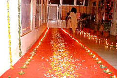 The hallway lined with 108 burning deepas and a bright red carpet for Pujya Swamiji's passage on the way to Mother Ganga.