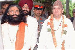 Pujya Swamiji walks with His Majesty the King of Nepal out of the puja ceremony.