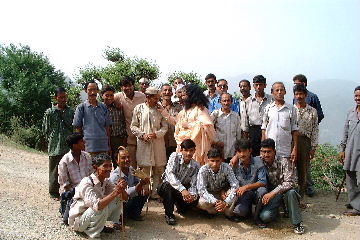 Pujya Swamiji feeding chocolate to the villagers